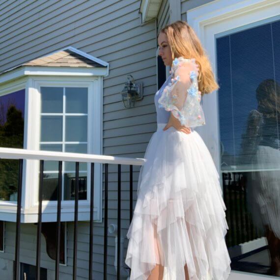 Light blue square neck bodice with long floral overlay sleeves, white midi tule skirt with layered lengths