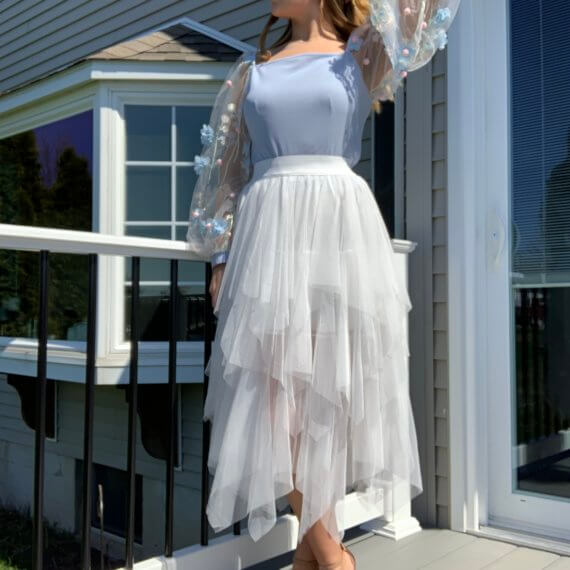 Light blue square neck bodice with long floral overlay sleeves, white midi tule skirt with layered lengths