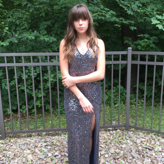 Grey/ silver sequin v-neck floor-length gown with spaghetti straps and a slit on the left side.