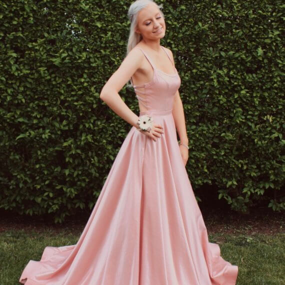 Pink scoop neck dress with spaghetti straps. The dress is a line and sold pink from top to bottom.