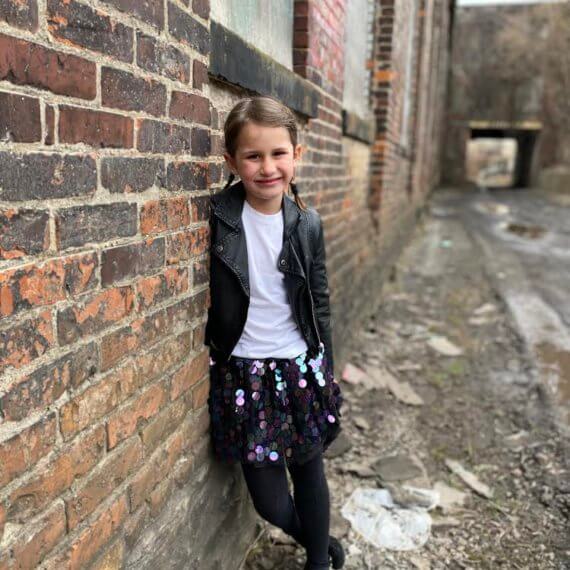 Look #7 Playful Glitter Stylist: Chie Kai Outfit: Mini spangle skirt, White shirtLeather jacket Shoes: Personal Collection Model: Evelyn Mager Photographer: Krysia Mager Location: Batavia, NY