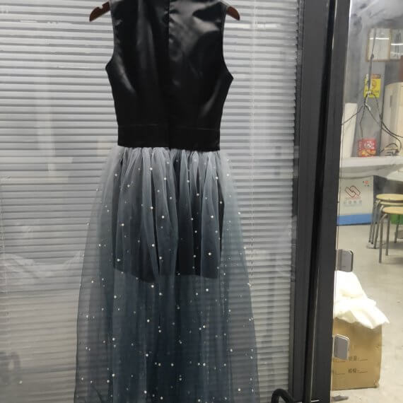 This dress is a black silk satin sleeveless mandarin collared halter shift dress with a white to black ombre silk chiffon pearl beaded long skirt.