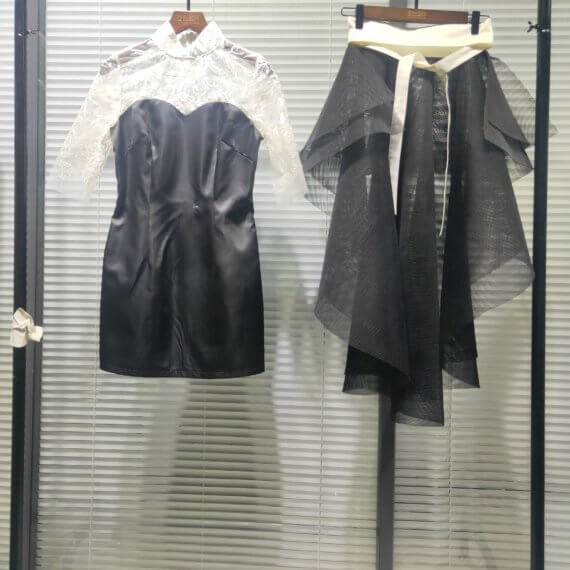 This 2 piece look begins with a black sweetheart neckline mini shift with contrasting white inset lace bodice, mandarin collar and elbow length sleeves. This mini is styled with a high low peplum two layer black tulle skirt tied at the waist with white satin bow.